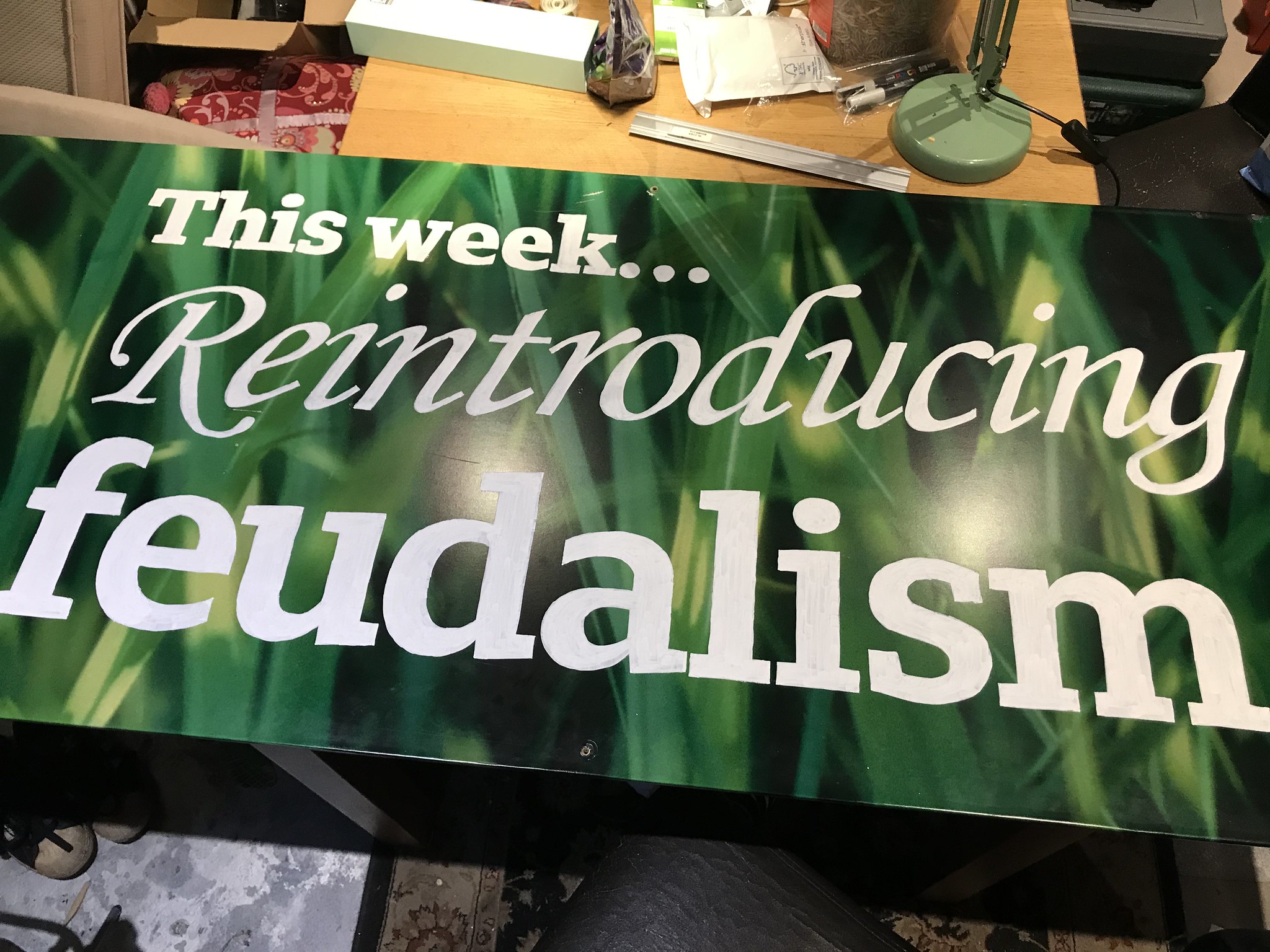 A sign with the words This week... Reintroducing feudalism in a variety of unserious fonts